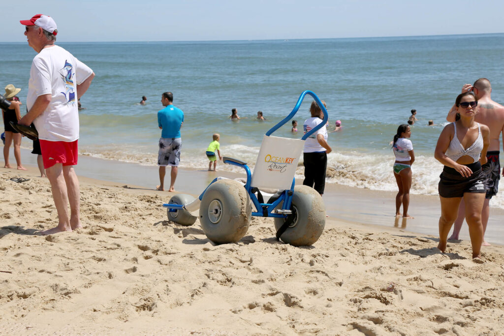 Sand Rider beach wheelchair with embroidered backrest at the beach