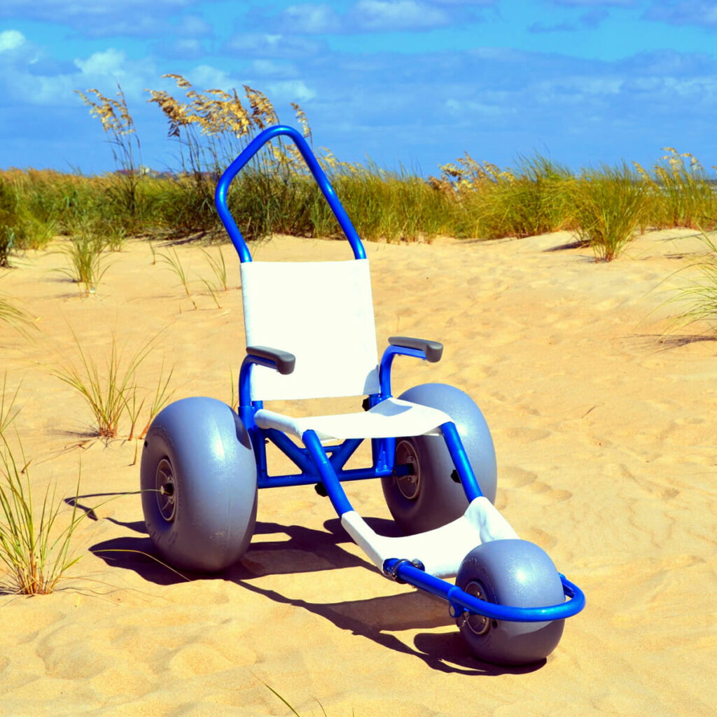 Blue Sand Rider beach wheelchair pictured on the sand